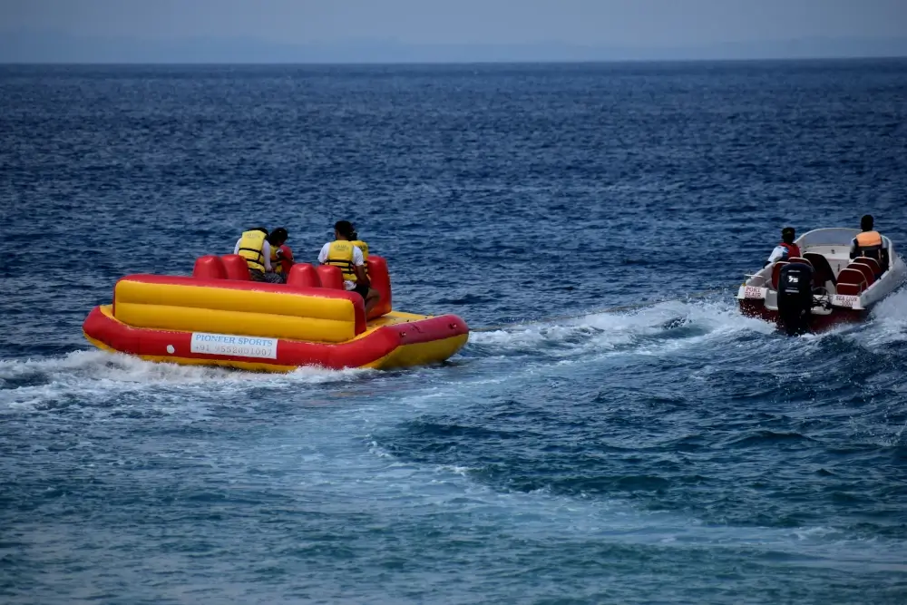 Tourist enjoying inflatable boat ride at Elephanta Beach